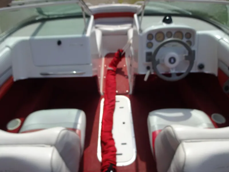 Slide: The Image of 1993 Chris-Craft 197 Concept boat interior with white and red seating, dashboard, and steering wheel. - 17