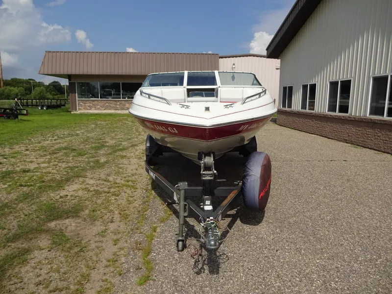Slide: The Image of 1993 Chris-Craft 197 Concept boat on a trailer outside a building. - 3