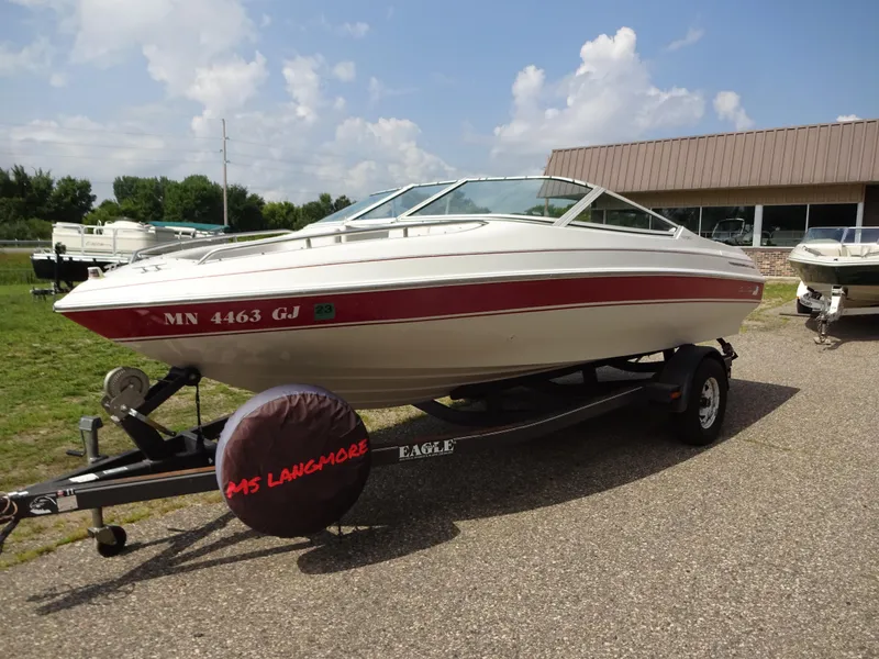 Slide: The Image of 1993 Chris-Craft 197 Concept boat on trailer, white with red stripe, outdoors. - 4