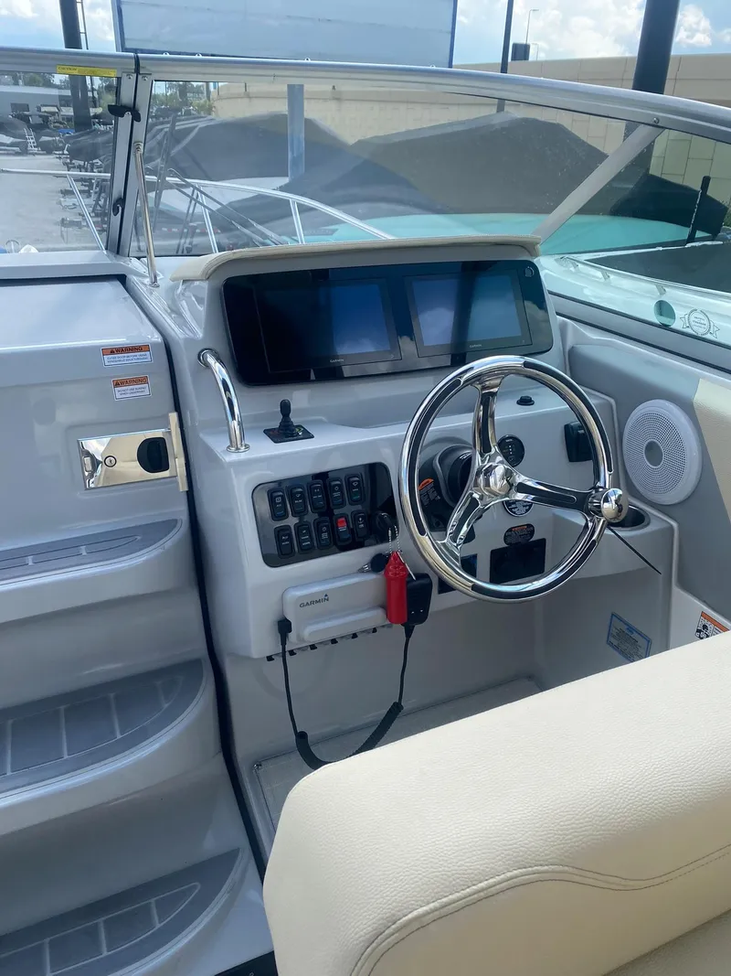 Slide: The Image of 2024 Regal 26 XO boat helm with modern controls and steering wheel. - 3