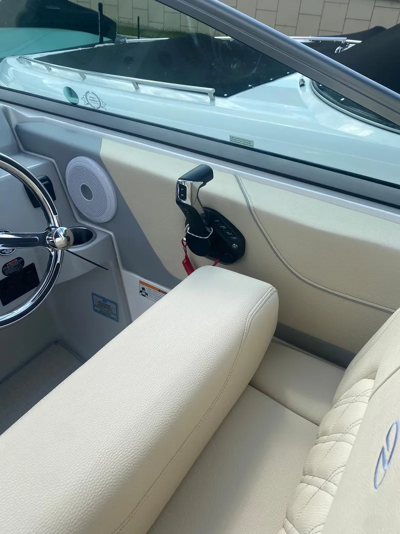 Slide: The Image of 2024 Regal 26 XO boat interior with steering wheel and throttle controls. - 4