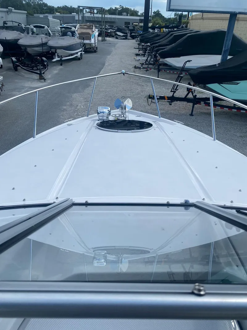 Slide: The Image of 2024 Regal 26 XO boat bow view at a marina. - 7