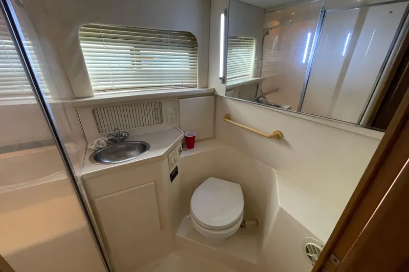 Slide: The Image of Bathroom interior of 1996 Carver 400 Cockpit Motor Yacht with sink and toilet. - 17