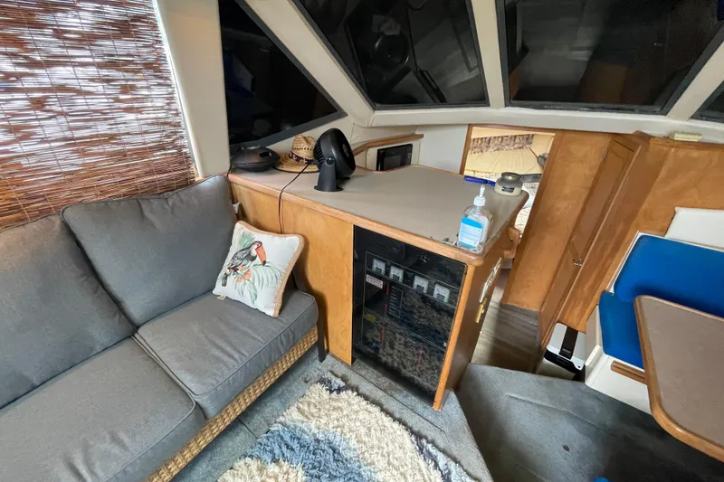 Slide: The Image of Interior of 1996 Carver 400 Cockpit Motor Yacht with cozy seating and modern amenities. - 8