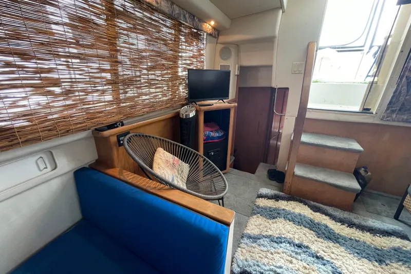 Slide: The Image of Interior of 1996 Carver 400 Cockpit Motor Yacht with cozy seating and TV. - 10