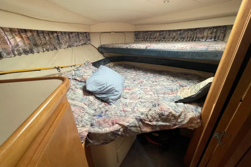 Slide: The Image of Interior cabin of 1996 Carver 400 Cockpit Motor Yacht with cozy bedding. - 12