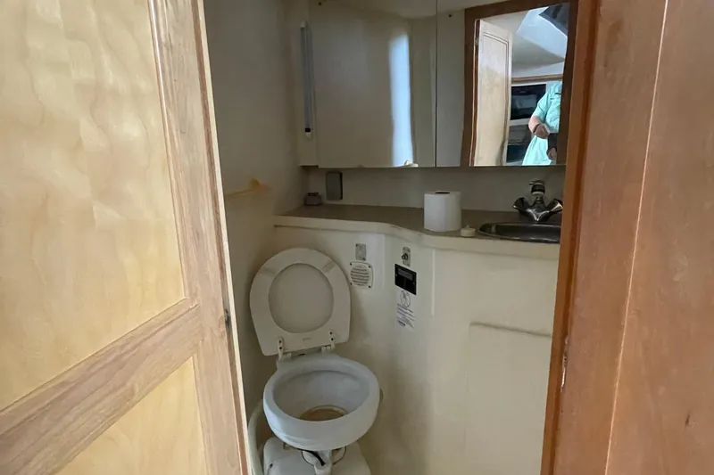 Slide: The Image of Bathroom interior of 1996 Carver 400 Cockpit Motor Yacht with toilet and sink. - 13