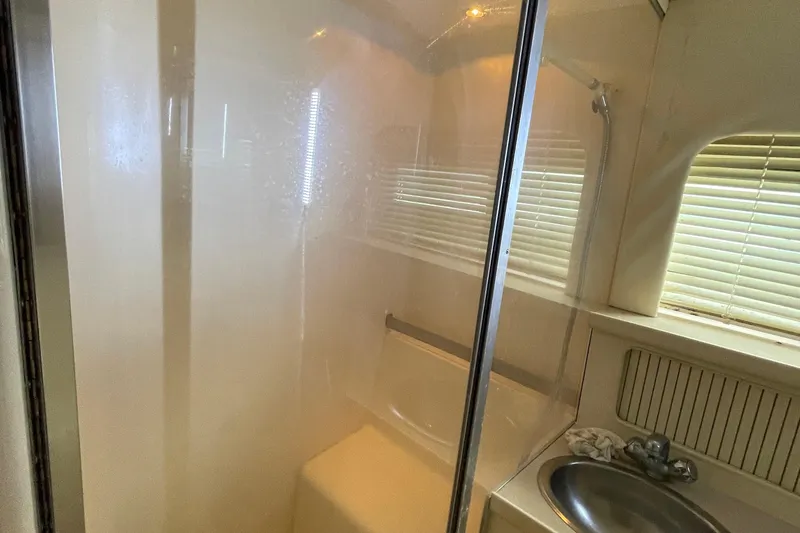 Slide: The Image of Shower area in 1996 Carver 400 Cockpit Motor Yacht with sink and window blinds. - 18