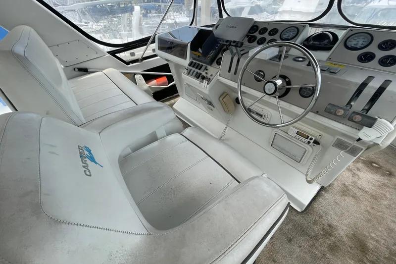 Slide: The Image of Interior of 1996 Carver 400 Cockpit Motor Yacht with steering wheel and control panel. - 5