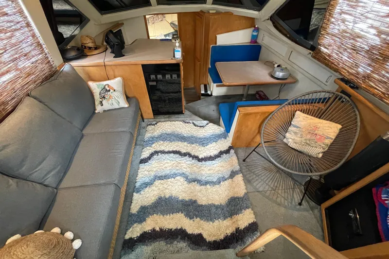 Slide: The Image of Interior of 1996 Carver 400 Cockpit Motor Yacht with cozy seating and decor. - 6