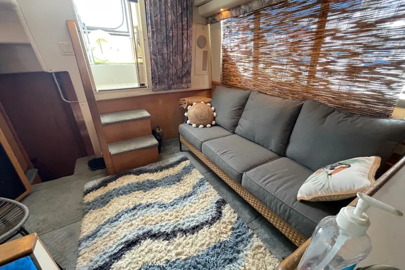 Slide: The Image of Interior of 1996 Carver 400 Cockpit Motor Yacht with cozy seating and decorative rug. - 9