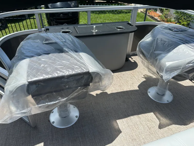 Slide: The Image of 2024 Ranger 220F boat interior with covered seats and center console. - 10