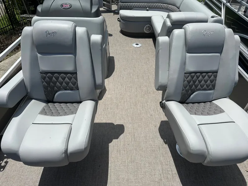 Slide: The Image of 2024 Ranger 220F boat interior with gray cushioned seats and diamond-patterned upholstery. - 3
