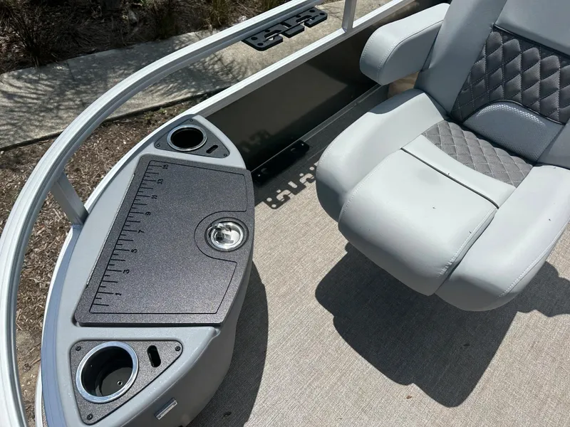 Slide: The Image of 2024 Ranger 220F boat interior with cushioned seat and console. - 4