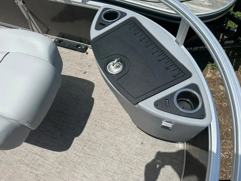 Slide: The Image of 2024 Ranger 220F boat console with cup holders and storage compartment. - 5