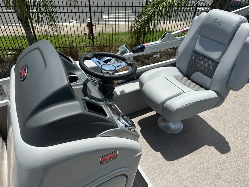 Slide: The Image of 2024 Ranger 220F boat cockpit with steering wheel and captain's chair. - 7