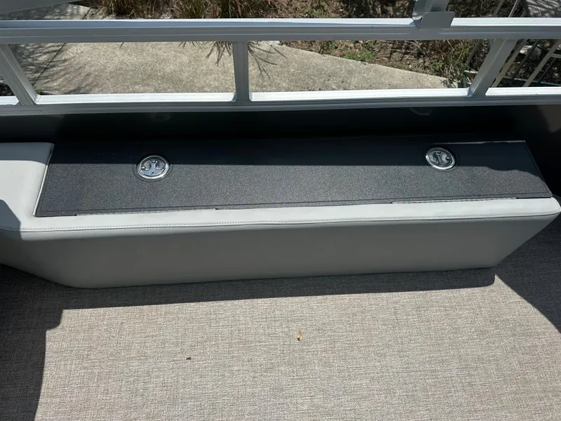 Slide: The Image of 2024 Ranger 220F boat storage compartment with dual latches. - 8