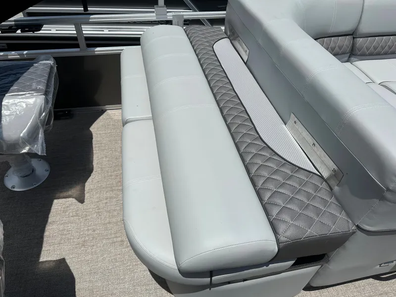 Slide: The Image of 2024 Ranger 220F boat interior with gray cushioned seating and diamond-stitched accents. - 9