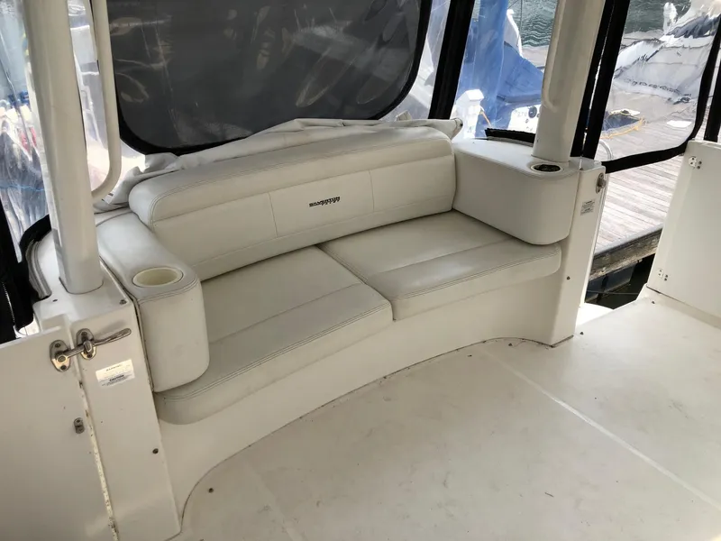 Slide: The Image of 2003 Silverton 35 Motor Yacht interior seating area with white leather upholstery. - 10