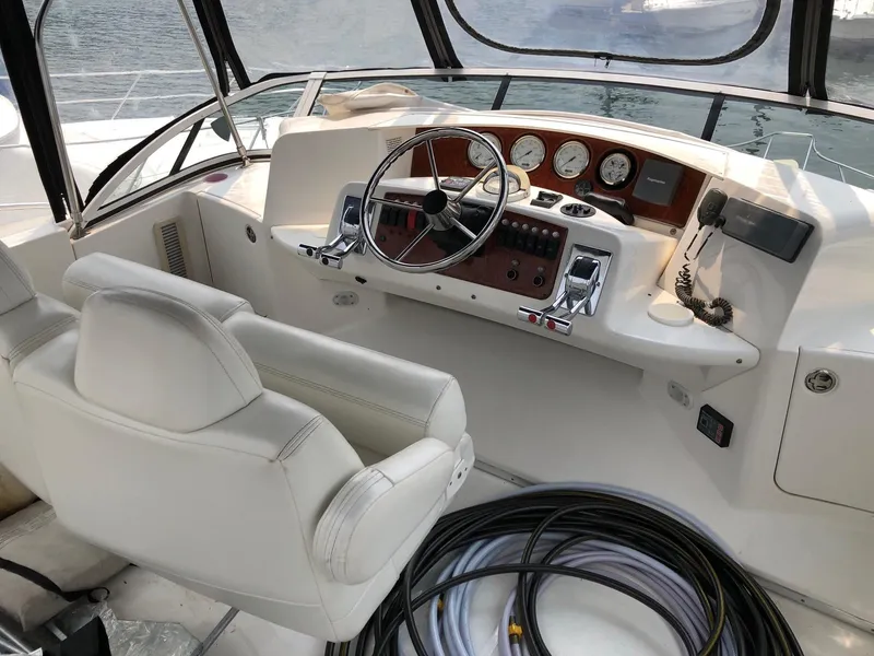 Slide: The Image of 2003 Silverton 35 Motor Yacht helm with steering wheel and control panel. - 11