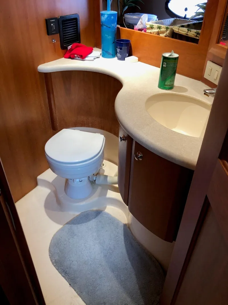 Slide: The Image of 2003 Silverton 35 Motor Yacht bathroom with toilet, sink, and countertop. - 22