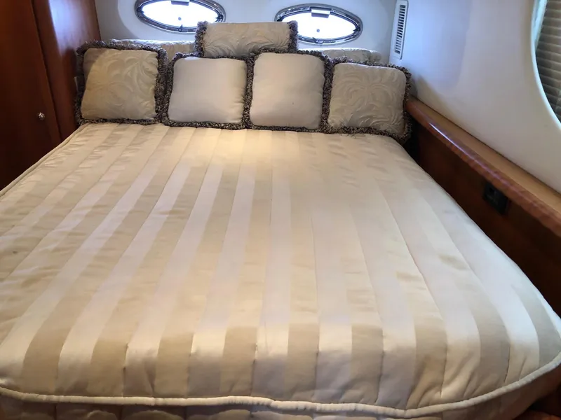 Slide: The Image of Luxurious bed in the 2003 Silverton 35 Motor Yacht cabin with elegant bedding and pillows. - 26