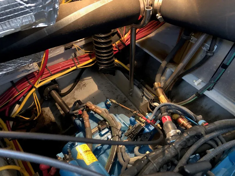 Slide: The Image of Engine compartment of a 2003 Silverton 35 Motor Yacht with visible wiring and hoses. - 38