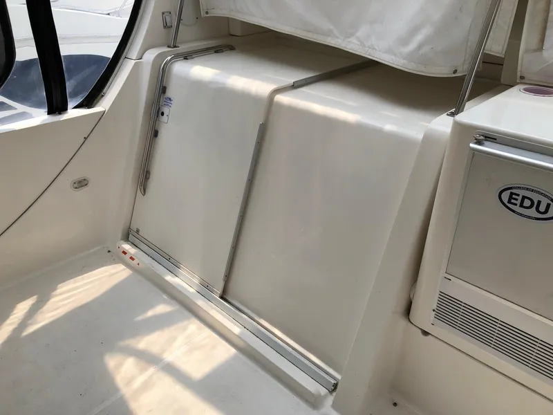 Slide: The Image of Interior view of a 2003 Silverton 35 Motor Yacht with white cabinetry and seating. - 6
