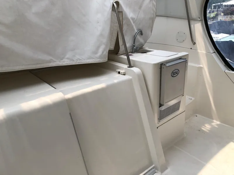 Slide: The Image of 2003 Silverton 35 Motor Yacht interior with covered seating and built-in ice maker. - 7