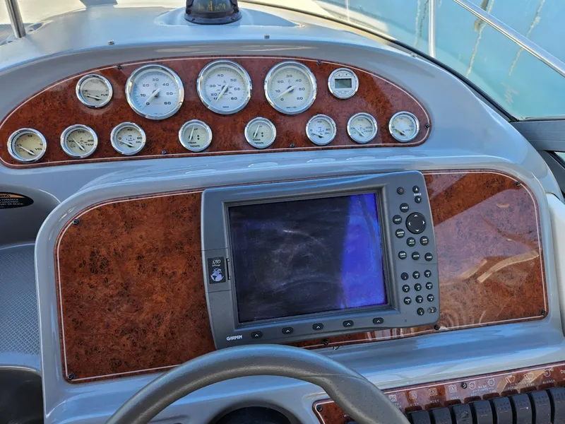 Slide: The Image of Dashboard of a 2006 Bayliner 305 boat with gauges and navigation system. - 14