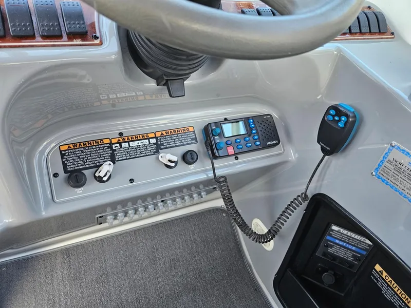 Slide: The Image of Control panel of a 2006 Bayliner 305 boat with radio and warning labels. - 15
