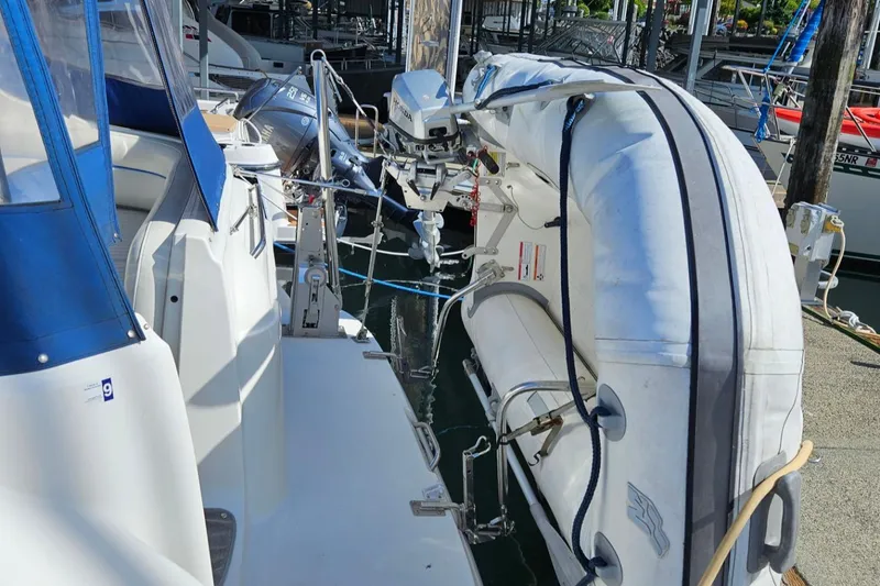 Slide: The Image of 2006 Bayliner 305 with inflatable dinghy docked at marina. - 19