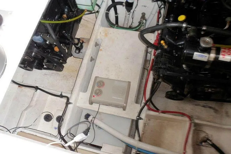 Slide: The Image of Engine compartment of a 2006 Bayliner 305 boat, showing dual engines and wiring. - 21
