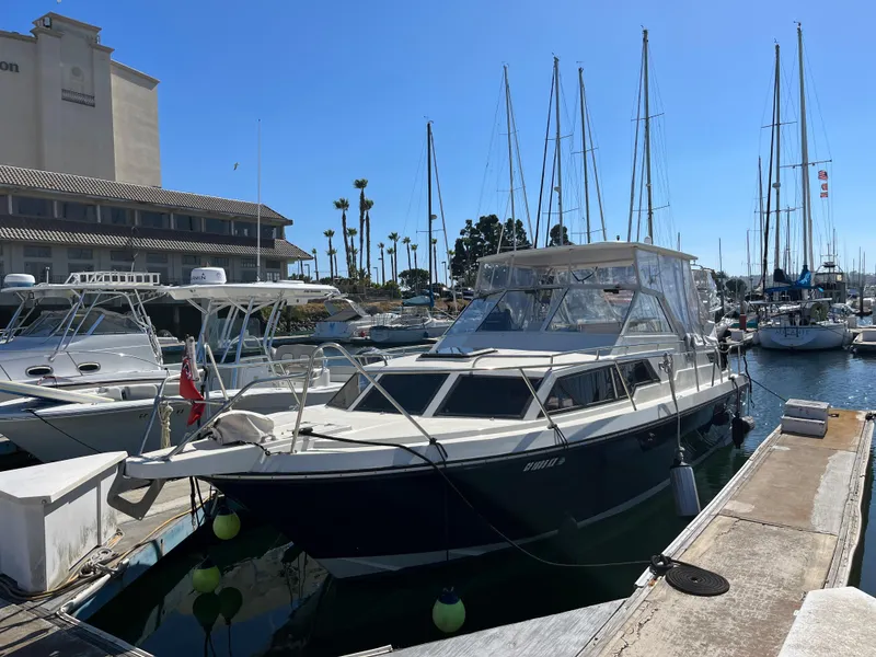 The Image of 1987 Scand Baltic boat docked at a marina with other vessels. - 0