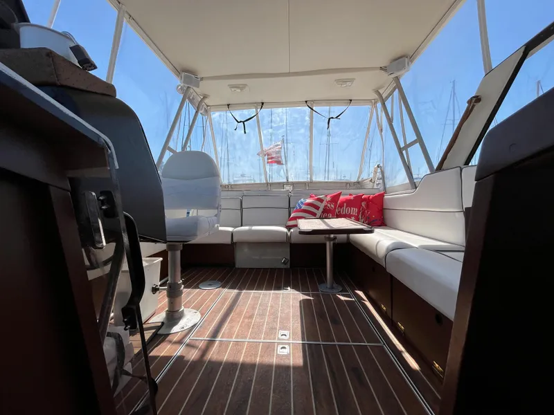 Slide: The Image of Interior of a 1987 Scand Baltic boat with wooden flooring and cushioned seating. - 10