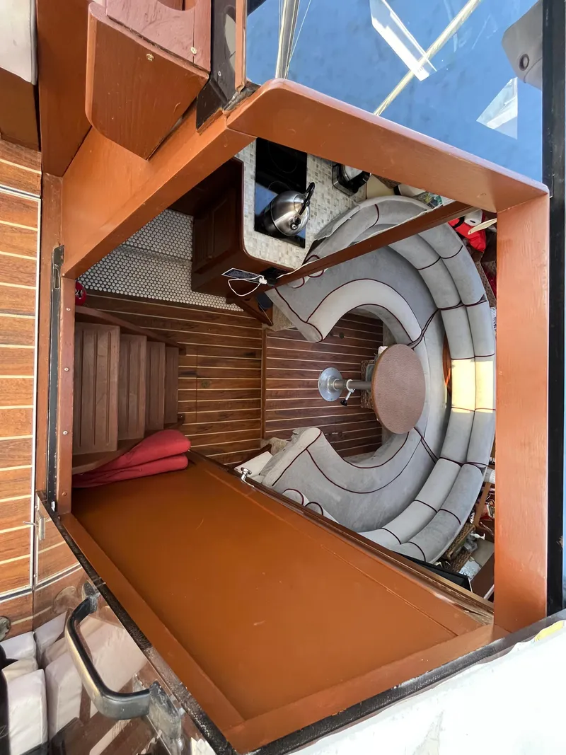 Slide: The Image of Interior of a 1987 Scand Baltic boat with wooden flooring and curved seating. - 13