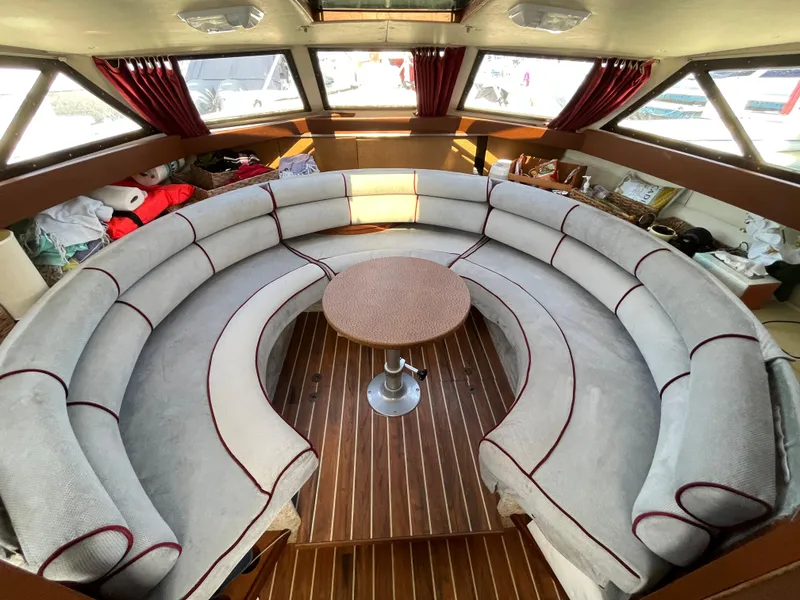 Slide: The Image of 1987 Scand Baltic boat interior with circular seating and wooden floor. - 14