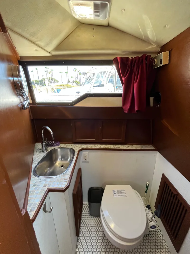 Slide: The Image of 1987 Scand Baltic boat bathroom with sink, toilet, and window. - 19