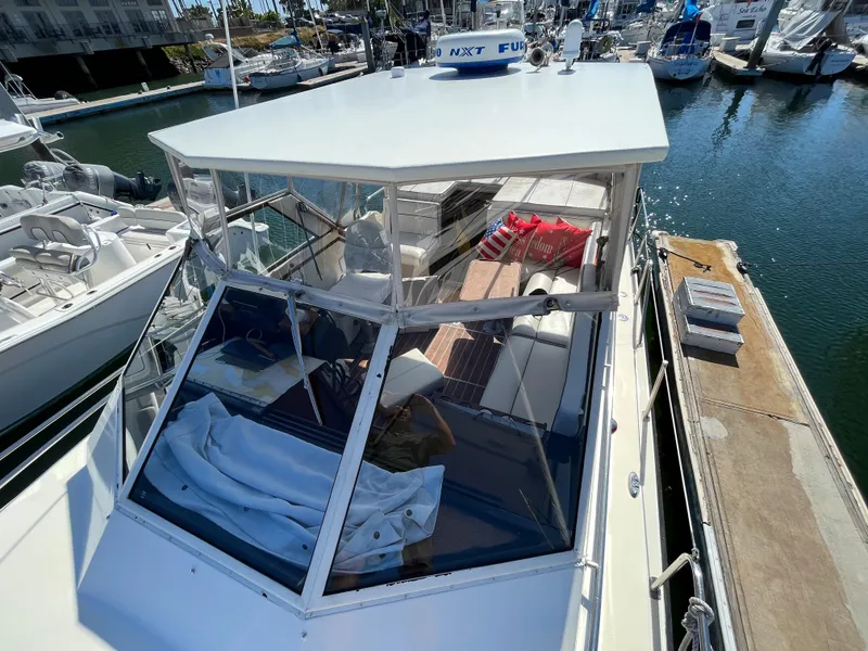 Slide: The Image of 1987 Scand Baltic boat docked at a marina, featuring a covered cockpit and seating area. - 5