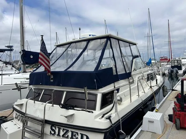 Slide: The Image of 1987 Scand Baltic boat docked at marina with American flag. - 6