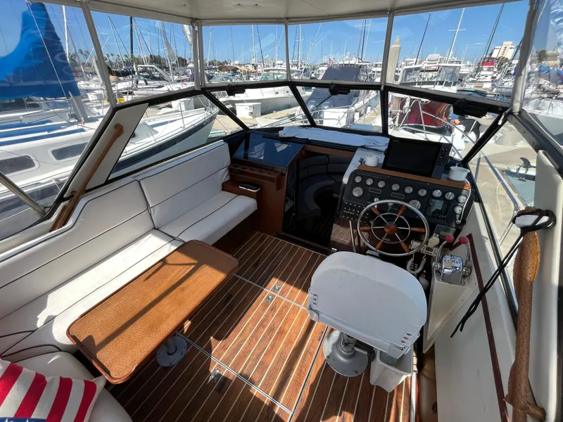 Slide: The Image of 1987 Scand Baltic boat interior with helm, seating, and marina view. - 8