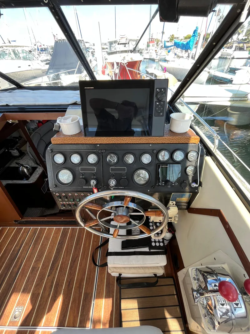 Slide: The Image of Helm of a 1987 Scand Baltic boat with navigation equipment and wooden flooring. - 9