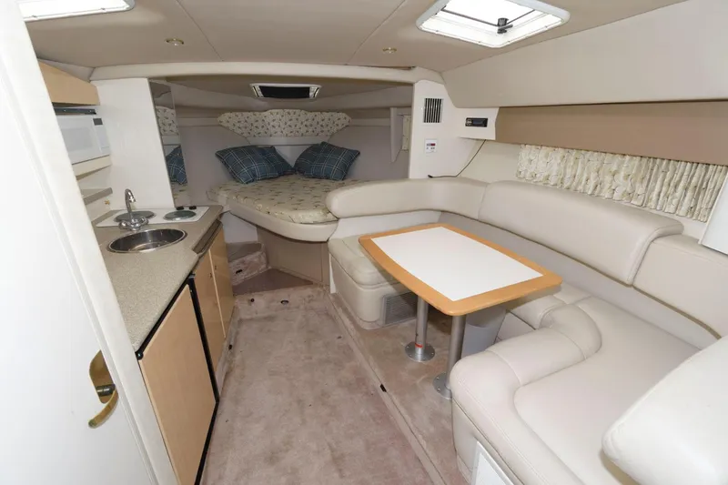 Slide: The Image of Interior of a 2000 Formula 31 PC boat with kitchenette, dining area, and sleeping quarters. - 11