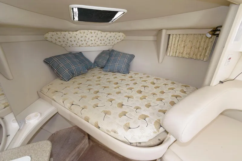Slide: The Image of Cozy cabin interior of a 2000 Formula 31 PC boat with bed and pillows. - 15