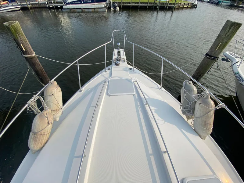 Slide: The Image of Bow view of a 2000 Formula 31 PC boat docked at a marina. - 3