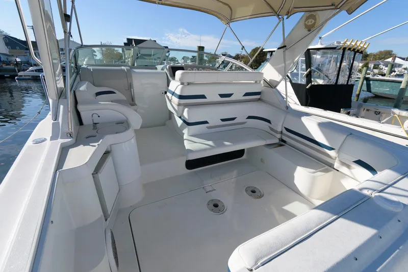Slide: The Image of 2000 Formula 31 PC boat interior with white seating and open deck. - 6
