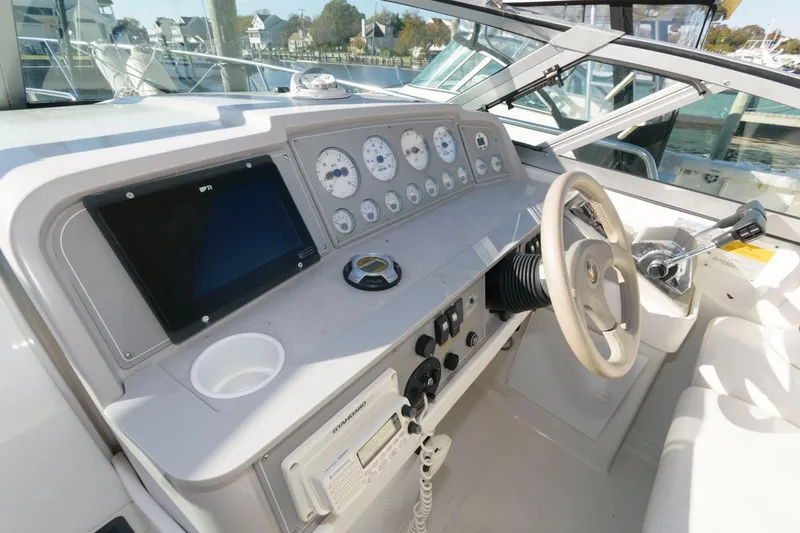 Slide: The Image of Cockpit of a 2000 Formula 31 PC boat with steering wheel and control panel. - 8