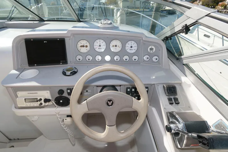 Slide: The Image of 2000 Formula 31 PC boat dashboard with steering wheel and control panel. - 9