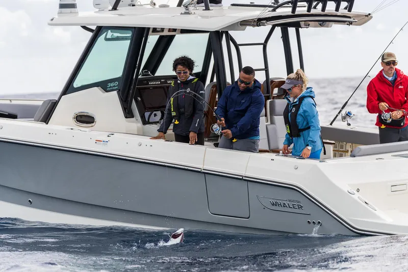 Slide: The Image of 2024 Boston Whaler 360 Outrage with people fishing at sea. - 11