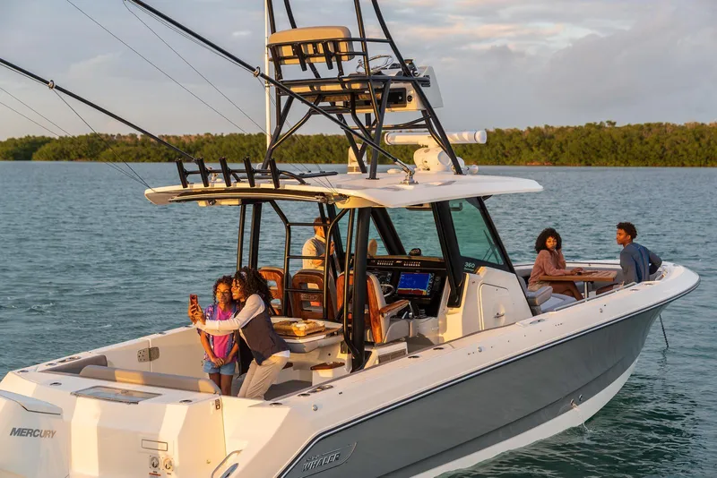 Slide: The Image of 2024 Boston Whaler 360 Outrage boat with people enjoying a day on the water. - 13